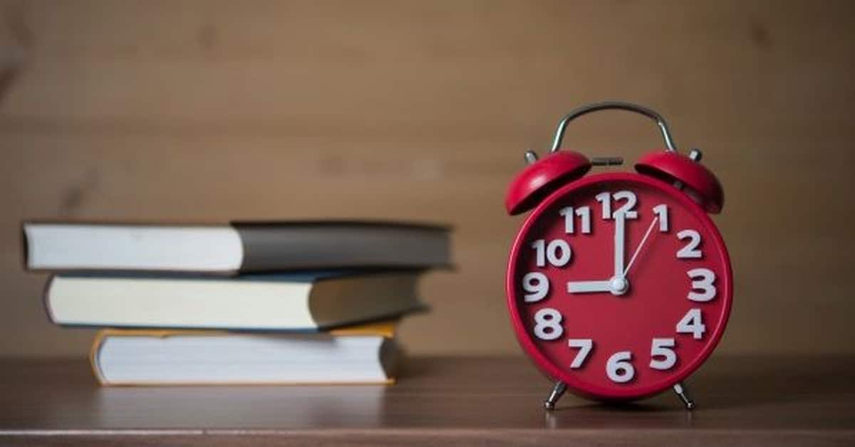 books and a clock on a table